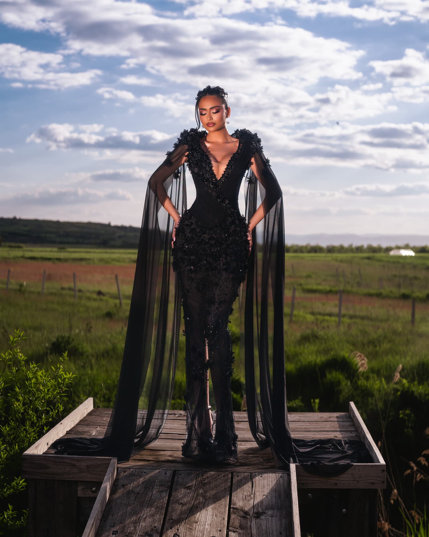 NOIRA — front portrait, cape sleeves drifting at sunset