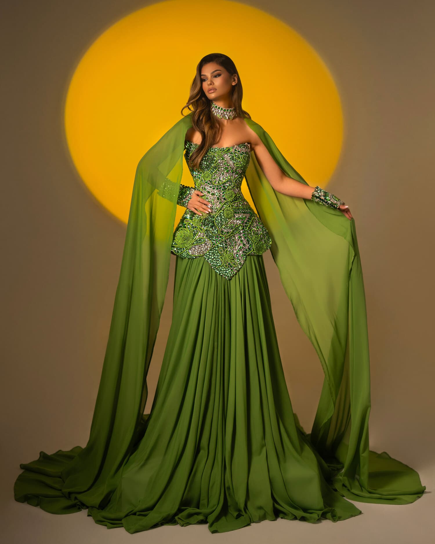 VERENA — olive-green chiffon gown with green sequin bodice and cape sleeves, ÉCLAT collection by BLINI