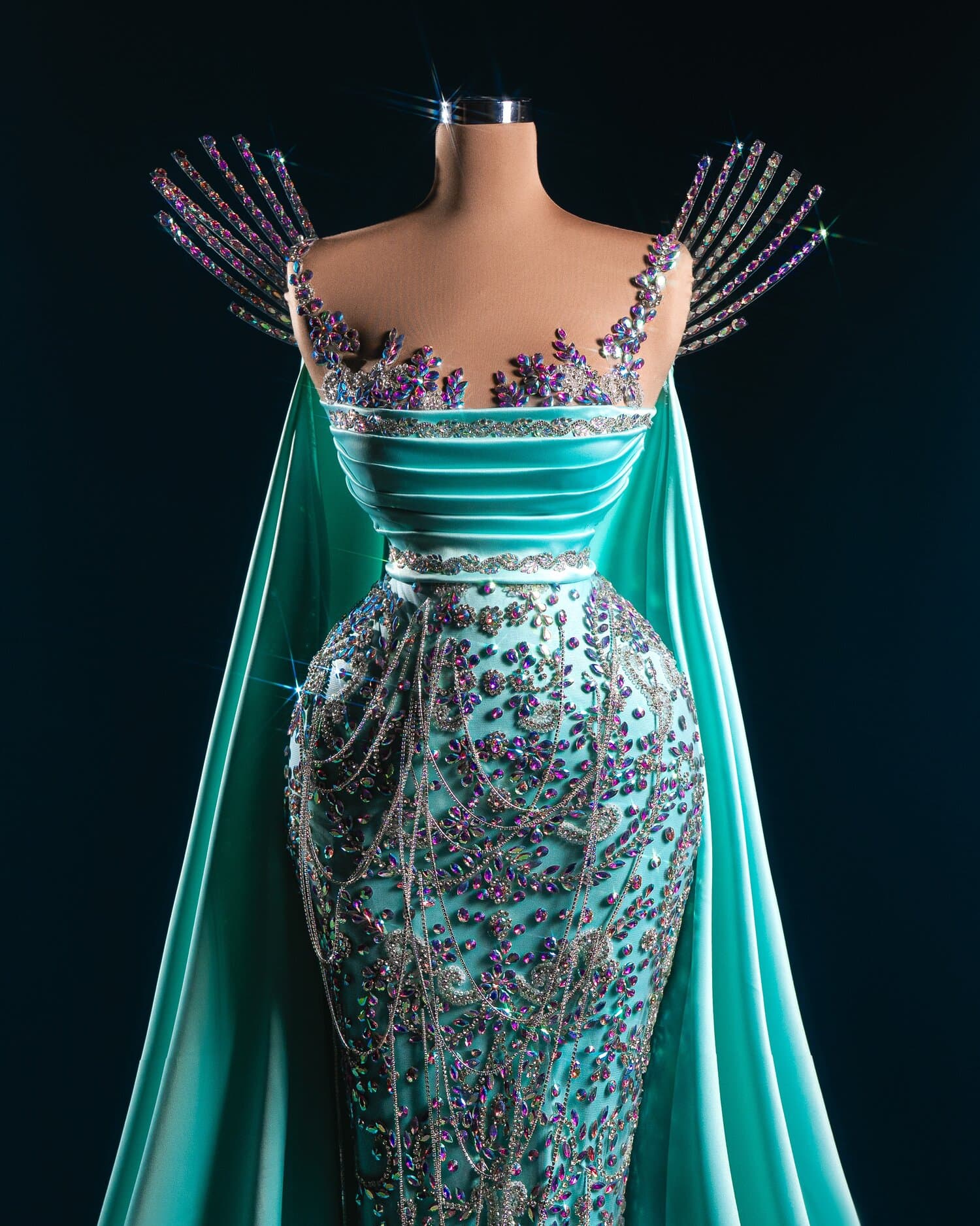 NIVARA — turquoise satin gown with crystal bodice and cape