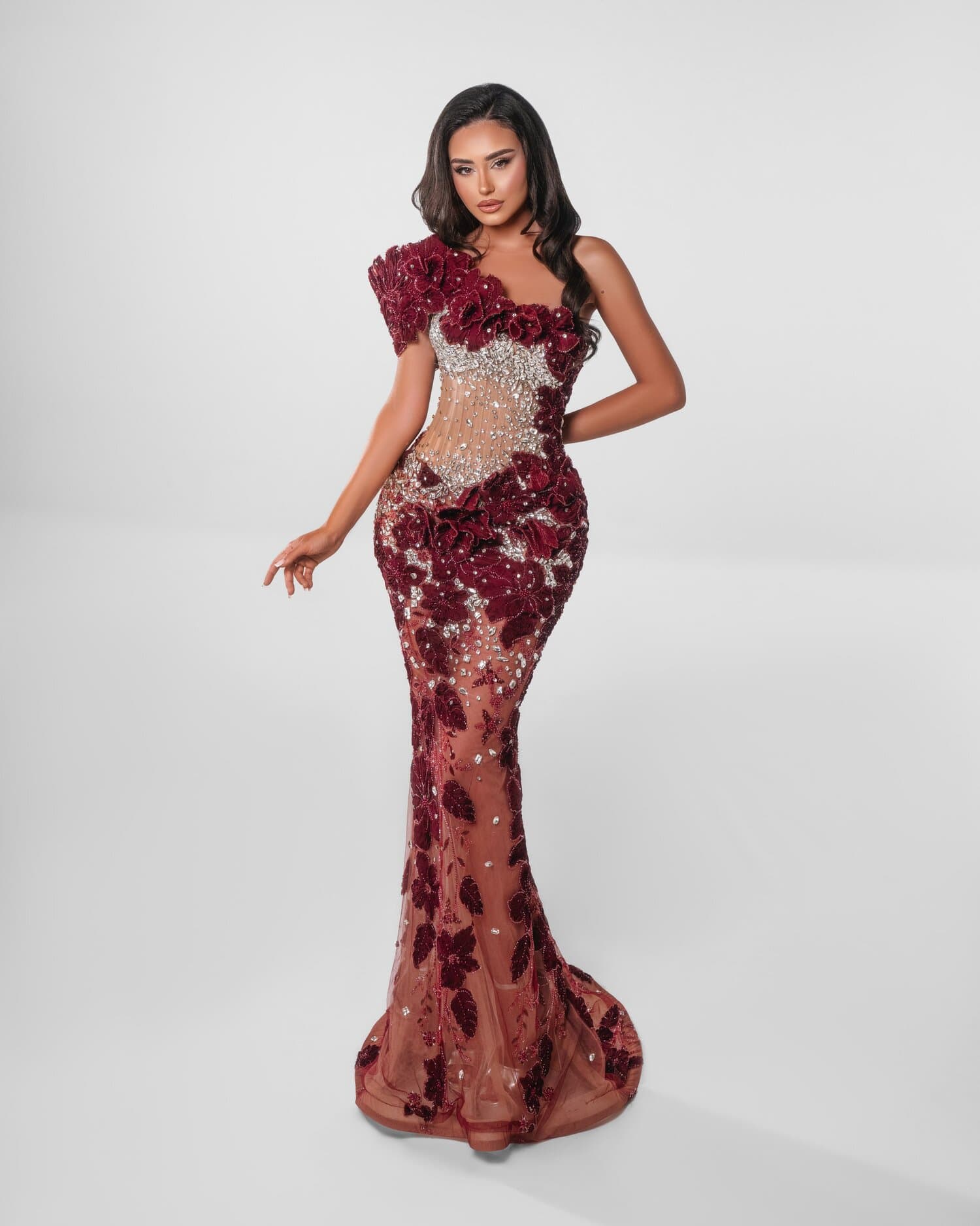RUBINELLE — Burgundy couture mermaid with a sculpted one-shoulder rosette, velvet blooms and