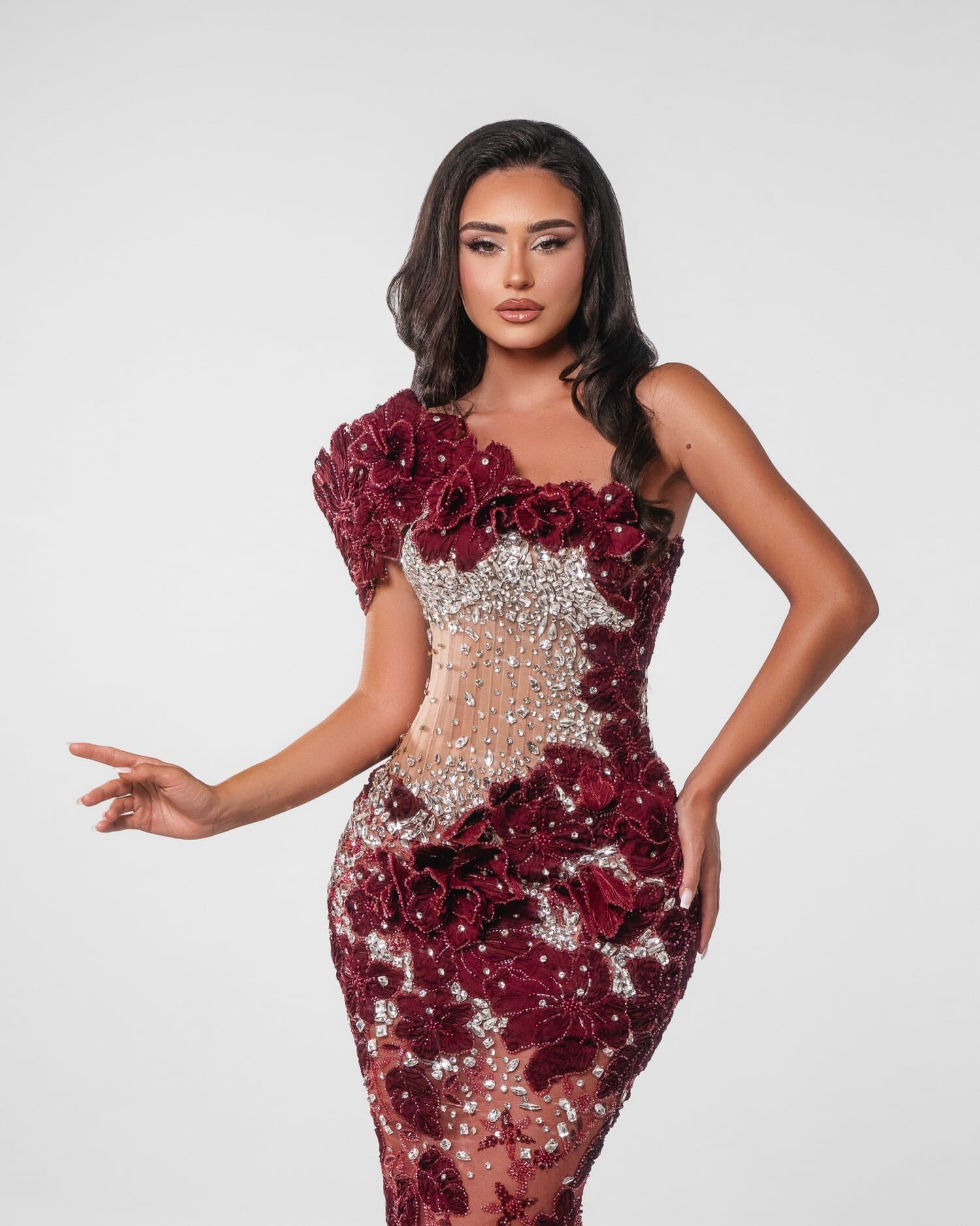 RUBINELLE — Burgundy couture mermaid with a sculpted one-shoulder rosette, velvet blooms and