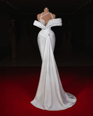 Zaena bridal gown featuring pearls and a flowing A-line silhouette.