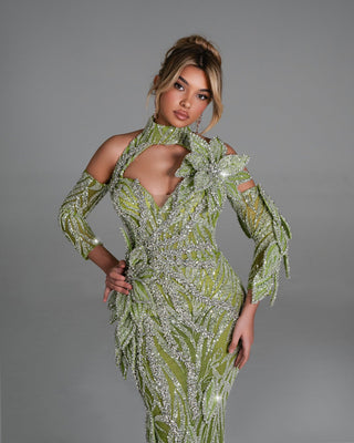 Model wearing the Addisonie Green Dress with crystal floral embellishments and leaf-inspired design details.