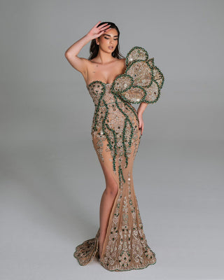 One-shoulder dress with leaf-inspired beadwork.