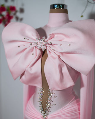 Ailana Pink Dress featuring delicate ribbon and crystal touches for a meaningful cause.