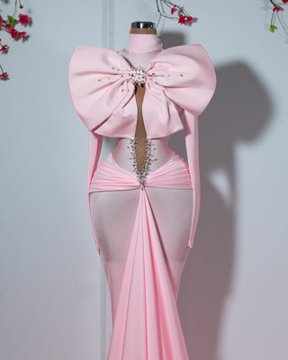 Handmade pink dress with ribbon detail, dedicated to breast cancer awareness.