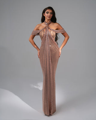 Elegant rose gold dress with sparkling details and draped accents.