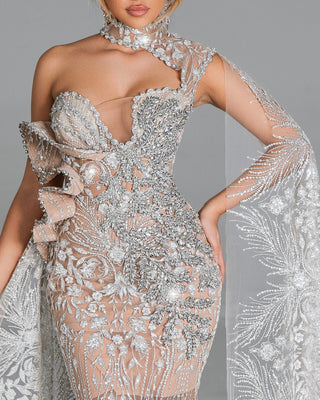 Fitted gown with sparkling crystals and dramatic lace accents.





