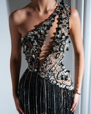 Close-up of black and silver short dress detailing with crystals and stones