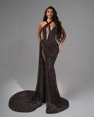 Elegant evening gown with halter neckline and high slit.
