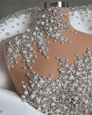 Close-up of embellished bodice with crystals and pearls on bridal dress