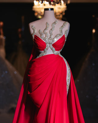 Boheme red dress with gold embellishments, featuring a flowing skirt and delicate gold detailing at the neckline.