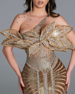 Stunning gold dress with intricate beadwork and dramatic off-shoulder leaves design.