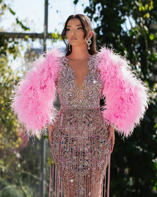 Camila dress with pink crystals and feather accents, blending elegance with modern flair.