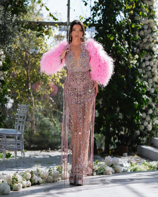 Pink crystal-embellished gown with soft feather details, perfect for high-fashion events.