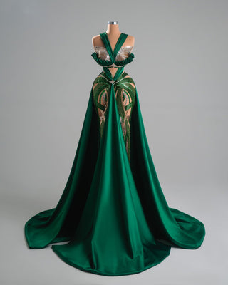 Elegant green dress with crisscross straps and shimmering embellishments.