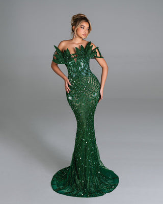 Elegant green dress featuring shimmering crystals and a fitted silhouette.