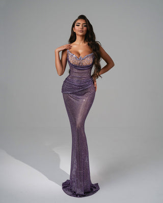 Shimmering purple dress with sparkling stones on the bust, a sweetheart neckline, and a mermaid-style silhouette.