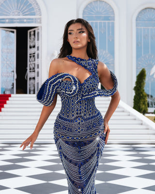 A blue dress embellished with silver stones and a unique neckline.