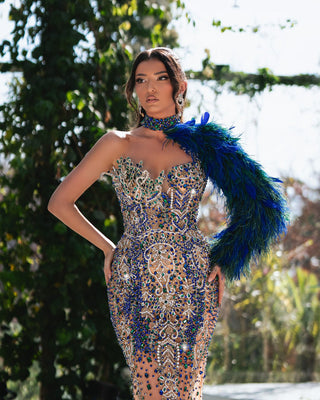 Handmade one-shoulder dress with shimmering crystals and feather accents.