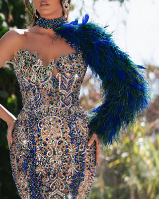 Luxurious one-shoulder dress adorned with crystals and soft feather details.