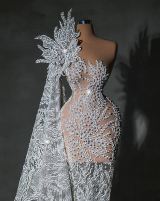 Evi Bridal Dress made from luxury fabric, adorned with shimmering crystals and delicate pearl designs.