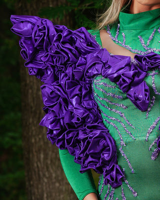 Close-up of purple sparkle embellishments on green dress