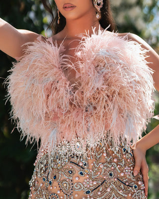 Chic V-neck dress in soft pink with playful feather embellishments.