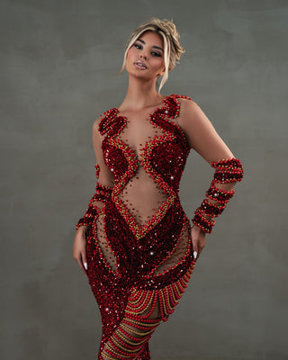 Long red gown embellished with red and gold beads