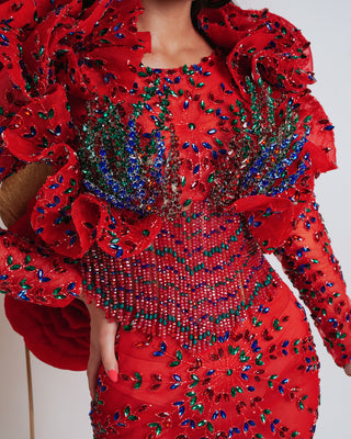 Close-up of intricate colorful stones and beads on luxury red dress fabric