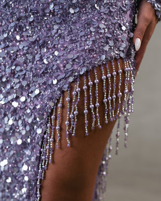 Detailed view of sequin fabric and beads on elegant light purple gown