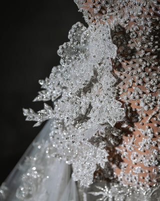 Isla Bridal Dress crafted from fine luxury fabric, embellished with radiant crystals, pearls, and intricate flower designs.