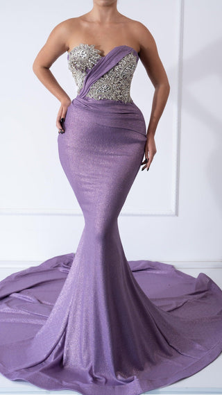 Violet gown with crystal embellishments and flowing skirt.