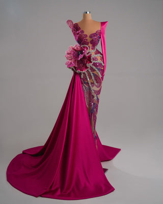 Elegant long pink dress featuring a crystal-embellished floral pattern and asymmetrical neckline.