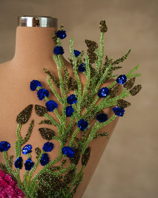 Close-up of floral embellishments on light green sleeveless dress