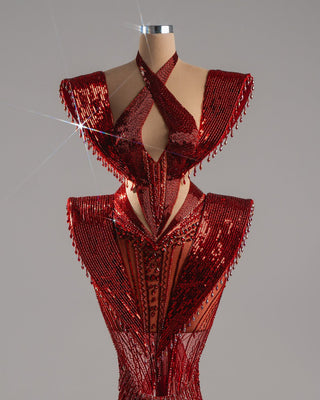 Red dress with winged shoulders and crystals.