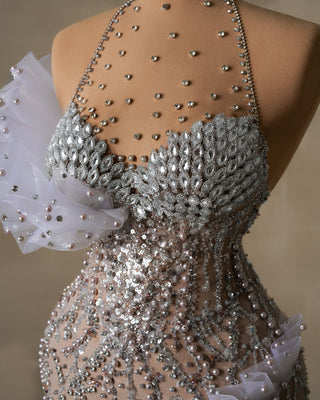 Crystal-studded halter dress with intricate ruffle details on the bodice.