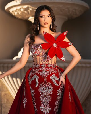 Regal red gown with silver embroidery and crystal embellishments.