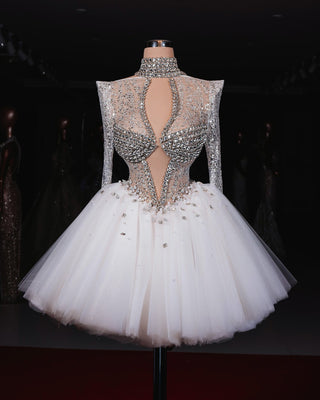 Elegant Lidia Short Bridal Dress with an open chest, long sleeves, and shimmering crystal embellishments.