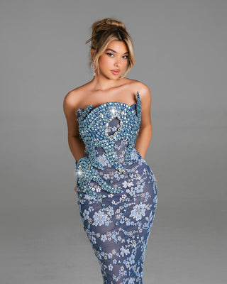 Elegant strapless floral mermaid gown with blue embellishments.