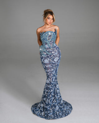 Intricately embroidered evening dress featuring shimmering floral patterns.
