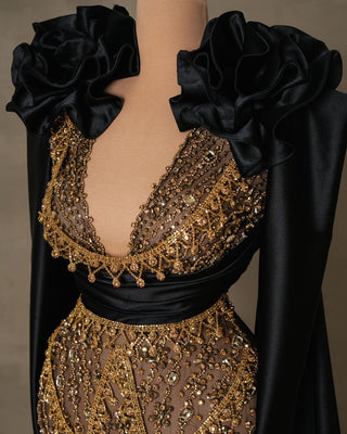 Close-up of black lace dress detailing gold stone embellishments and 3D satin flowers