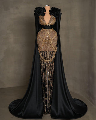 Elegant black lace dress featuring gold stones, 3D satin flowers, and dramatic side capes