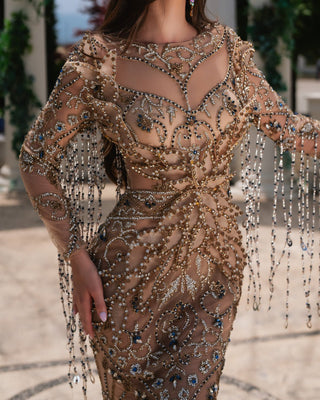 Close-up of the Mara Nude Dress showcasing its intricate crystal accents.