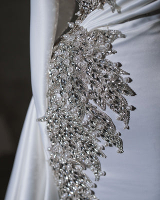 Sophisticated bridal dress with a flattering silhouette and intricate crystal and pearl details.