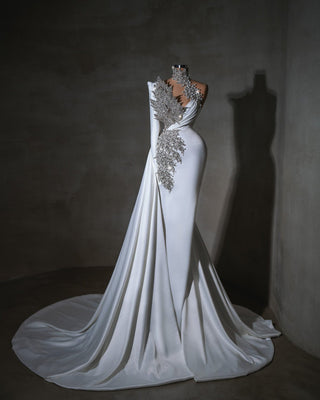 Dramatic wedding dress featuring a high crystal neckline and shimmering one-shoulder design.