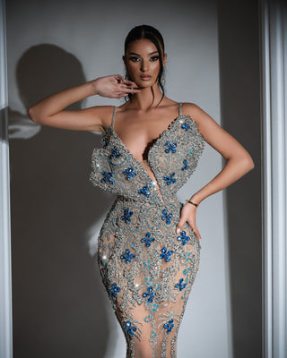 Luxurious silver dress featuring cut-out chest, thin straps, and intricate silver and blue crystal embellishments