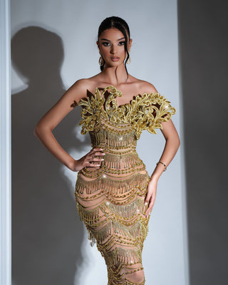 Elegant gold dress, tea-length, embellished with gold tassels and sparkling stones