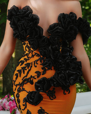 Close-up Detail of Black Flower Embellishments on Orange Dress