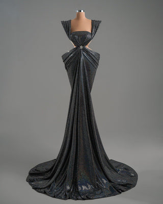 Elegant gray evening dress featuring sculptural straps and a flowing silhouette.